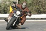 Person in Bigfoot costume riding motorcycle